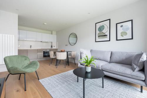 a living room with a couch and a table at Montana Apartment - Modern Comfort & Prime Location in London