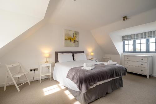 a bedroom with a large bed and a window at 5 Oakes Court in Thorpeness