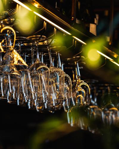 a bunch of wine glasses hanging from a rack at OTTON-Charzykowy Bed&Restaurant in Chojnice