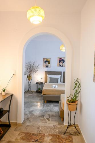 a bedroom with a bed and a couch in a room at 3 Goddesses' studios in Koukounaries