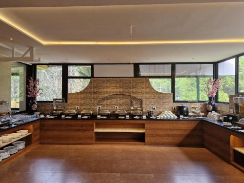a kitchen with a large counter with windows at Golden Landmark Green Valley Beach Resort in Dona Paula