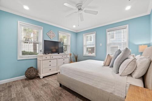 a bedroom with a bed and a flat screen tv at Forever Coastal With Game Room And Private Beach in Destin