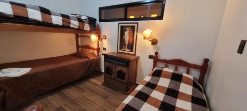 a bedroom with two bunk beds and a fireplace at CASA de PURMAMARCA in Purmamarca