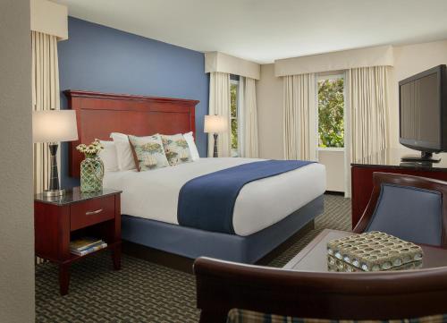 a hotel room with a bed and a tv at Bristol Harbor Inn in Bristol