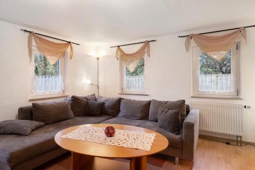 a living room with a couch and a table at Haus an der Landhege in Mainhardt
