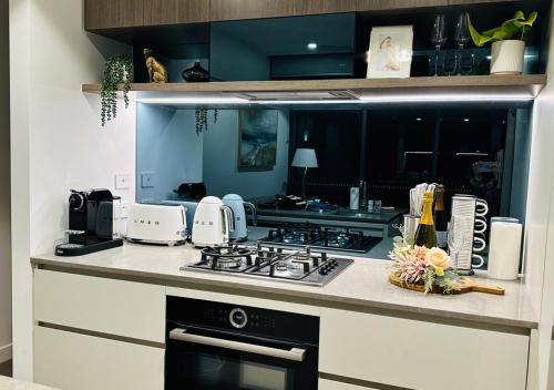 a kitchen with a stove and a counter top at Brisbane CBD Luxury Apartment 8 Margaret St in Brisbane