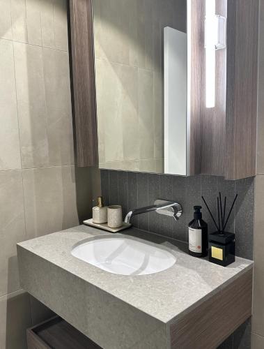 a bathroom with a sink and a mirror at Brisbane CBD Luxury Apartment 8 Margaret St in Brisbane