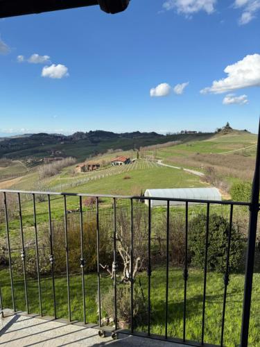 a balcony with a view of a green field at Villa Biancospino - luxury and private villa in Langhe in Monforte dʼAlba