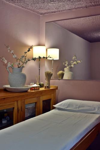 a bedroom with two lamps and a bed with flowers at La Comarca Hotel in Purmamarca