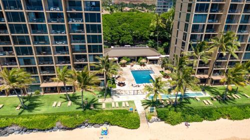 an aerial view of a resort with a pool and palm trees at Mahana by KBM Resorts in Kaanapali