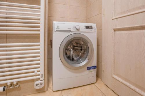 a washer and dryer in a small room at Louren Apartments in Prague