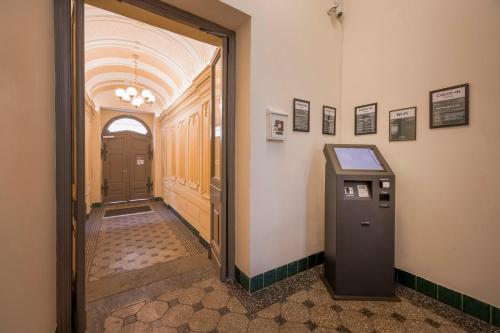 an empty hallway with a pay phone in a building at Louren Apartments in Prague