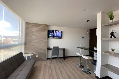 a living room with a couch and a table at Domus Suites Chia in Chía