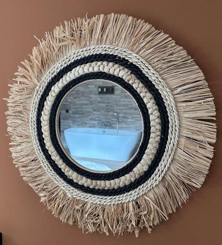 a large rope wreath hanging on a wall at Au repos du Vicomte in Cockaifagne
