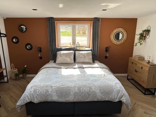 a bedroom with a large bed and a window at Au repos du Vicomte in Cockaifagne