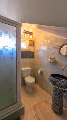 a bathroom with a toilet and a sink and a shower at Beachside Living in Centre de Flacq