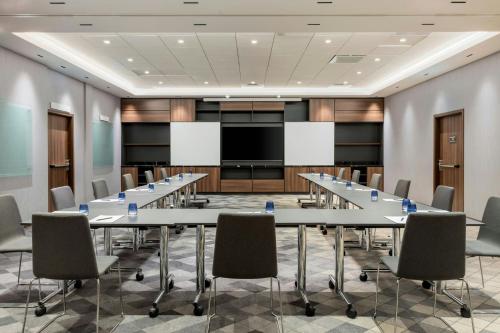 a conference room with a long table and chairs at AC Hotel by Marriott Stockholm Ulriksdal in Solna