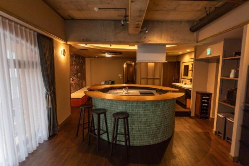 a kitchen with a island in the middle of a room at THE HOTEL of TOKYO Akasaka in Tokyo