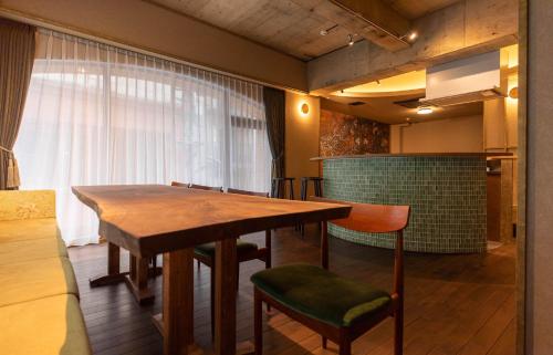 a dining room with a wooden table and chairs at THE HOTEL of TOKYO Akasaka in Tokyo