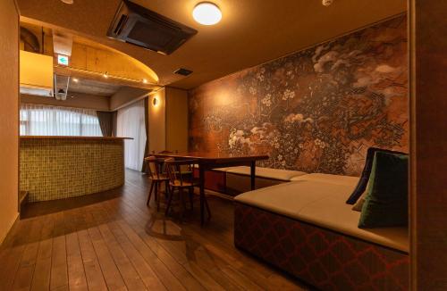 a bar with a couch and a table in a room at THE HOTEL of TOKYO Akasaka in Tokyo