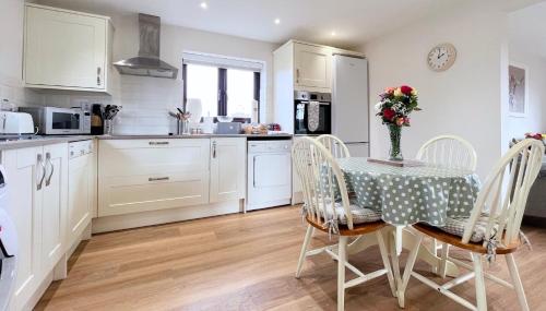 a kitchen and dining room with a table and chairs at Guest Suite King Bed in Chew Valley Bath Somerset in Chew Magna