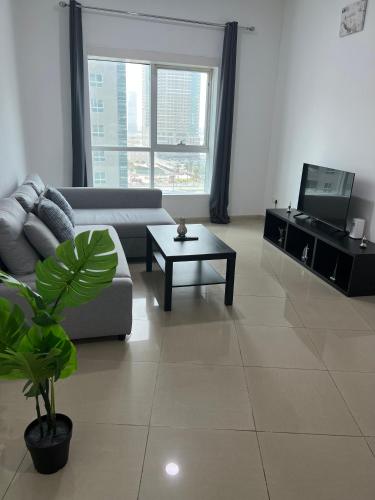 a living room with a couch and a coffee table at Top Rated Award Winning 1BR with Sea View in Sharjah