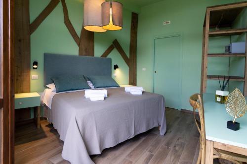 a bedroom with a bed in a room with green walls at CSA Hotel Beach & Park in Marina di Bibbona