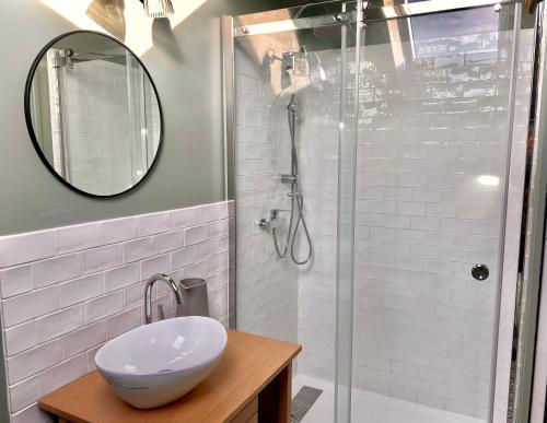 a bathroom with a sink and a shower with a mirror at Tashi Kampa, The House of Happiness in Tibetan in Montigny-sur-Loing