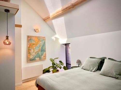 a bedroom with a bed and a map on the wall at Tashi Kampa, The House of Happiness in Tibetan in Montigny-sur-Loing