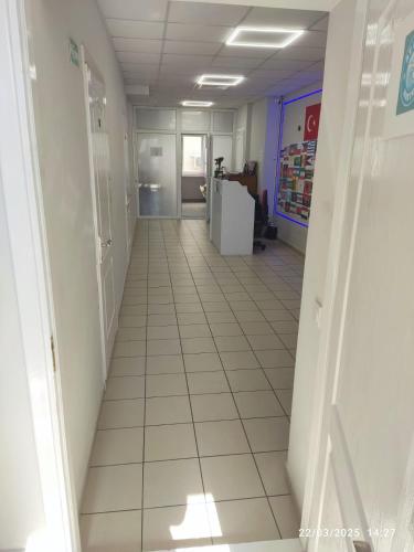 an empty hallway in a store with a tile floor at Aydeniz hostel in Chişinău