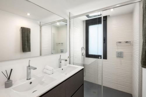a white bathroom with a sink and a shower at Villa Angelique, 5 BDR with Heated Private Pool in Puerto Banus in Marbella
