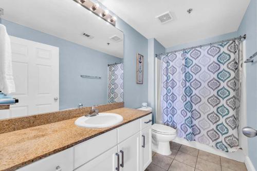 a bathroom with a sink and a toilet and a shower at Laketown Wharf 1803 in Panama City Beach