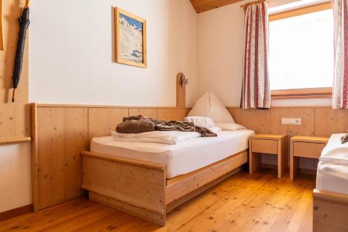 a bedroom with a bed and a window at Rossalm in Brixen