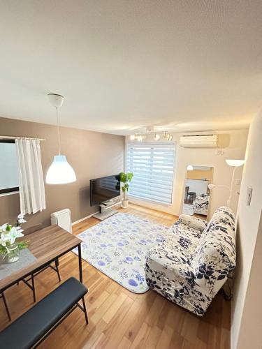 a living room with a couch and a table at Ueno new villa in Tokyo