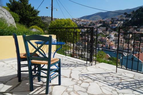 a table and chair on a patio with a view of a city at Panoramic View House in Symi