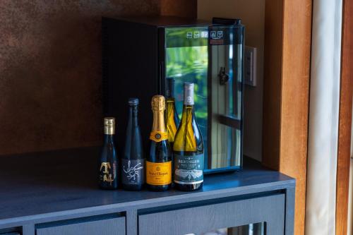 a group of bottles of wine sitting on a table at Hakone Yumoto Onsen Hotel Kajikaso in Hakone