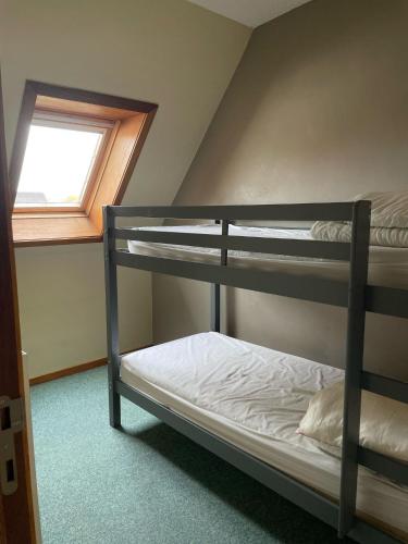 two bunk beds in a room with a window at Apparthotel De Wielingen in Westende Bad