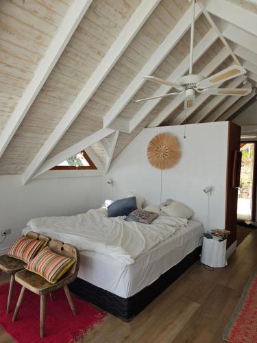 a bedroom with a large bed and a ceiling at Harbour View House Villa in Port Elizabeth