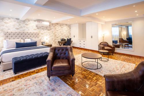 a bedroom with a bed and a living room at Pax Manor Muthaiga in Nairobi