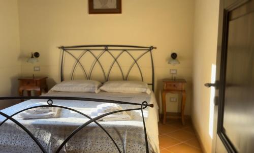 a bedroom with a bed with a metal frame at Naturalya in Vibonati