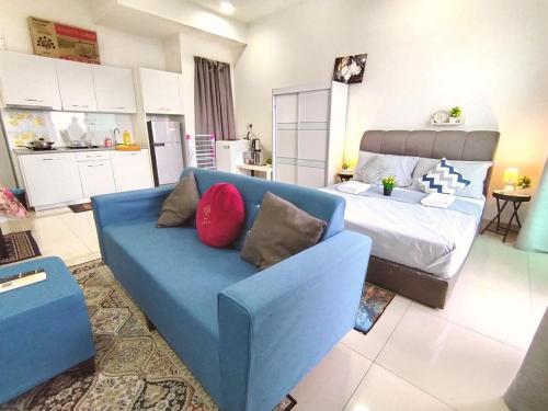 a blue couch in a living room with a bed at C-25-06 Lakeviewsouth Cybersquare WiFi Netflix FreeParking in Cyberjaya