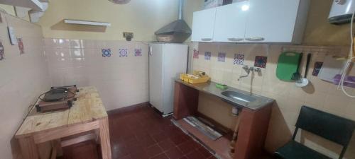 a small kitchen with a sink and a refrigerator at Vidala in Tilcara
