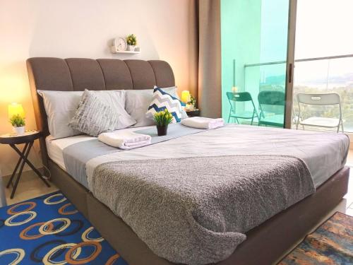 a large bed in a bedroom with a balcony at C-25-06 Lakeviewsouth Cybersquare WiFi Netflix FreeParking in Cyberjaya