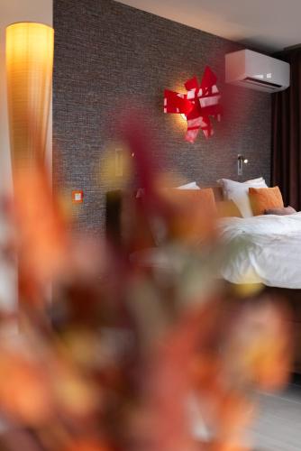 a bedroom with a bed with a red bow on the wall at B&B Carpe Diem in Westerlo