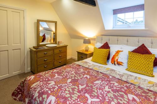 a bedroom with a large bed and a mirror at Harmony House Boutique B&B in Stillingfleet
