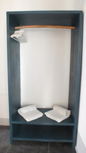 two folded towels on a shelf in a room at Rocca d'Anfo B&B-Apartments Lake View in Rocca dʼAnfo