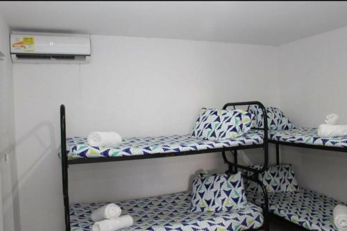 a room with three bunk beds in a room at Hotel Los Delfines Melgar in Melgar