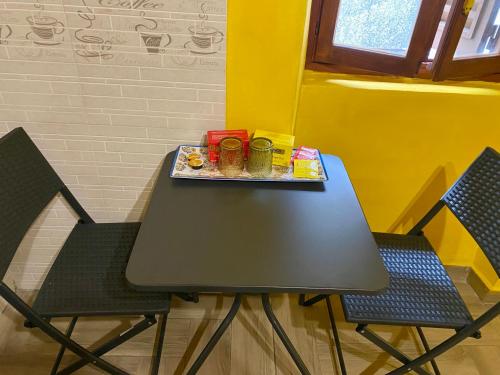 a table with two chairs and a tray of food on it at B&B il Parco stanza Garibaldi in Oriolo Romano