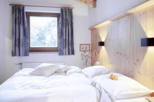 a white bed in a bedroom with a window at Club Nordic in Sankt Anton am Arlberg
