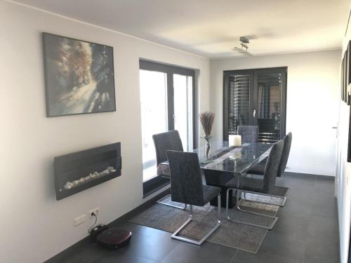 a dining room with a table and chairs and a fireplace at Entire Apartment in Schieren - 2 Bedrooms in Schieren
